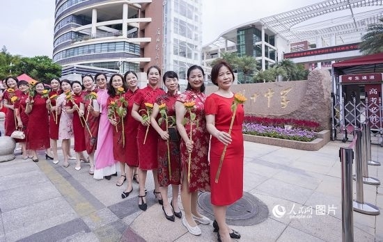 6月7日一早，廈門雙十中學(xué)考生家長們身穿旗袍，手拿向日葵在考場外為孩子加油打氣，寓意“旗開得勝，一舉奪魁”。人民網(wǎng)記者 陳博攝