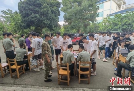 專武干部在發(fā)放兵役登記證。韋碩 攝