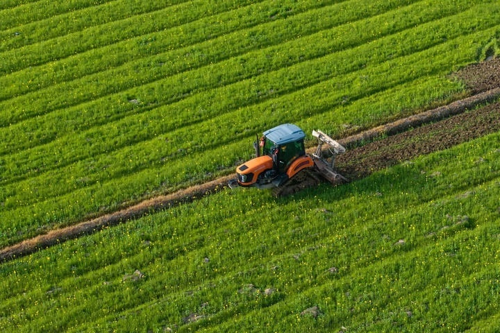 2024年3月19日，在湖南省常德市鼎城區(qū)謝家鋪鎮(zhèn)港中坪村，村民駕駛農(nóng)機(jī)翻耕田地（無人機(jī)照片）。新華社記者 陳思汗 攝