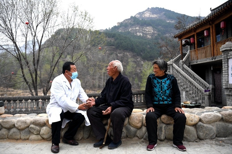 2020年4月15日，在河北阜平縣龍泉關(guān)鎮(zhèn)駱駝灣村，村醫(yī)霍建國為村民把脈。
