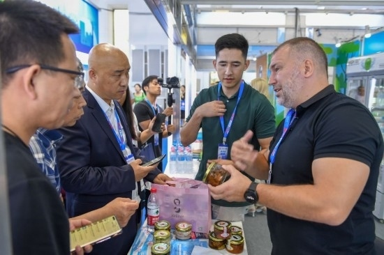 2023年8月23日，在第十四屆中國—東北亞博覽會東北亞商品館，俄羅斯參展商向參觀者介紹商品。
