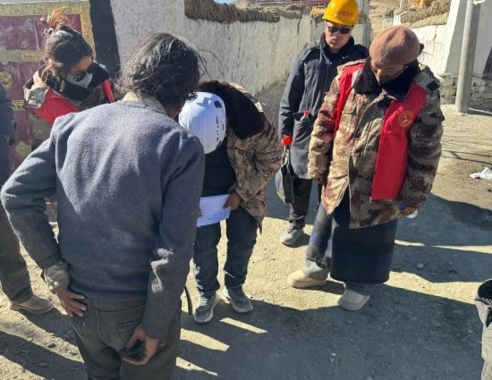 1月13日，次旺（右一）陪同工作組走訪村莊，評(píng)估房屋受損程度。新華社發(fā)