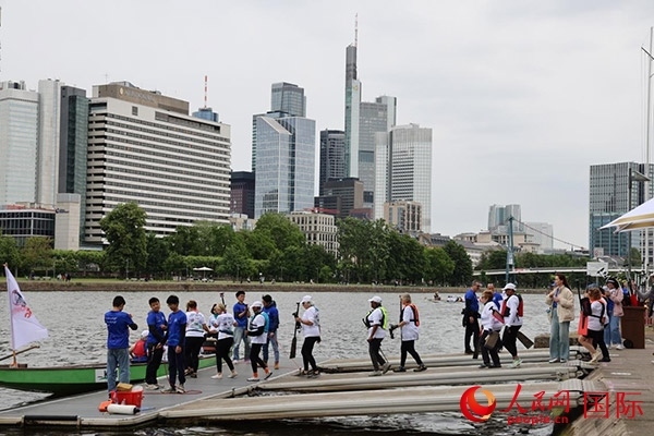 來自美國的快樂龍舟隊選手們正在登船準(zhǔn)備參賽。人民網(wǎng)記者 劉仲華攝